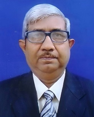 Headshot of a smiling woman with long dark hair wearing a black blazer and white shirt