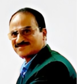 Headshot of a smiling woman with long dark hair wearing a black blazer and white shirt